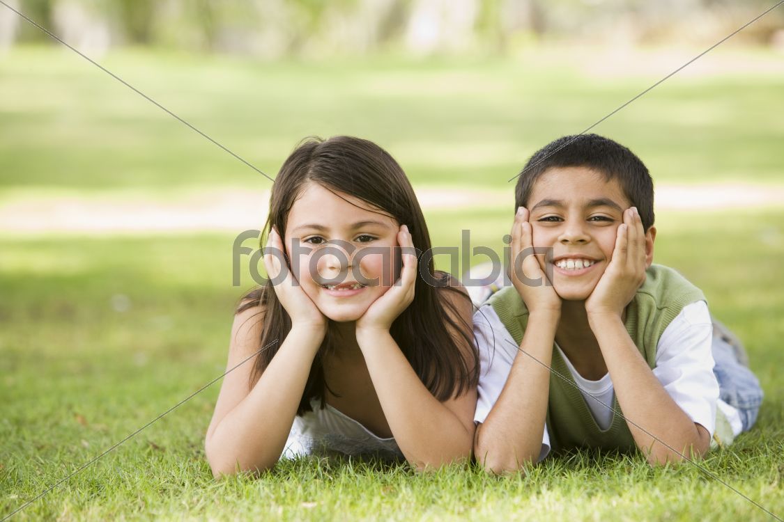 Two children relaxing in park