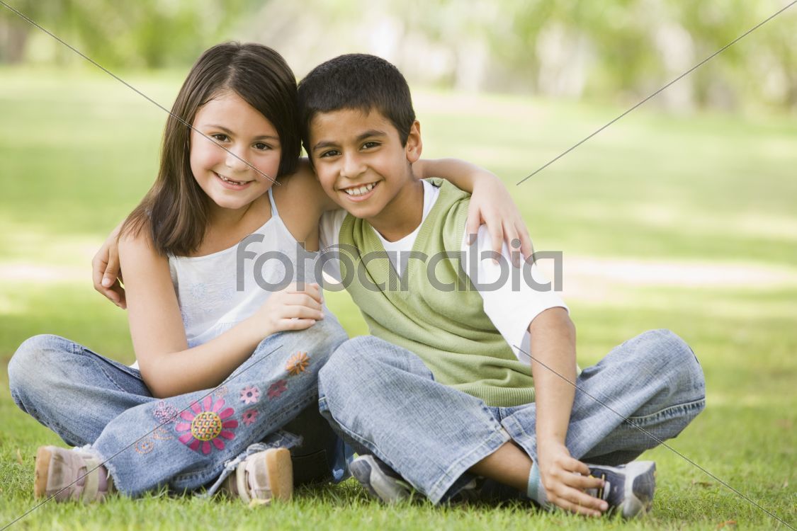 Two children sitting in park