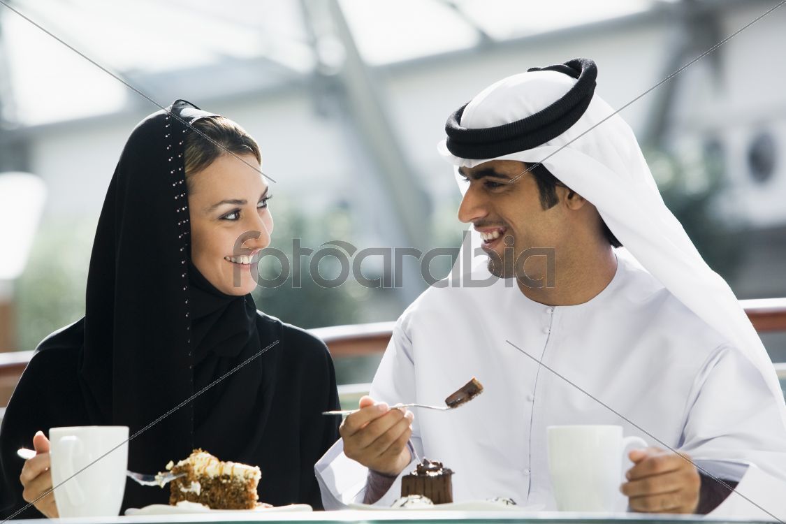 A Middle Eastern couple enjoying a meal in a restaurant