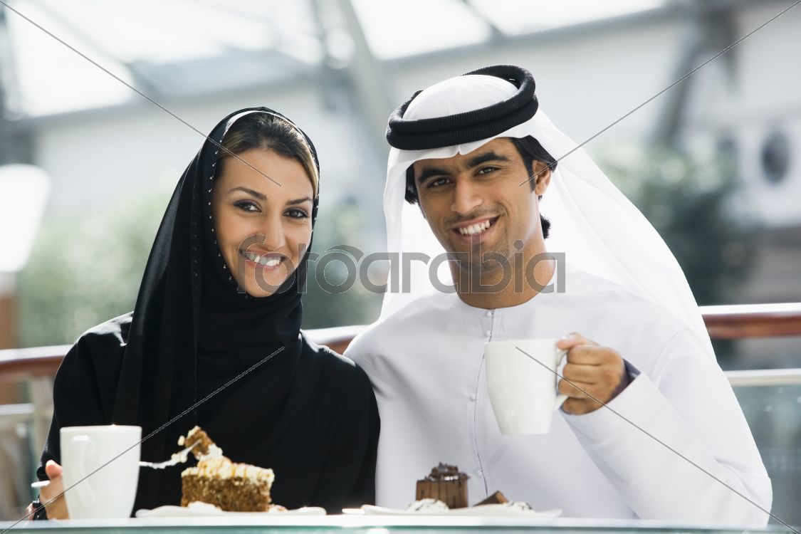 A Middle Eastern couple enjoying a meal in a restaurant