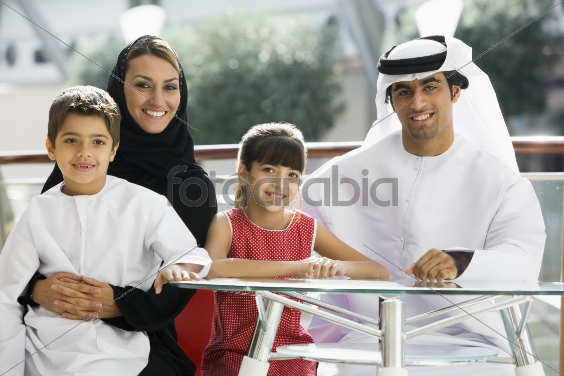 A Middle Eastern family enjoying a meal in a restaurant