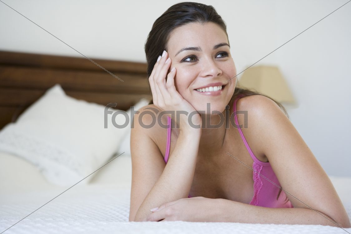 A Middle Eastern woman lying on a bed