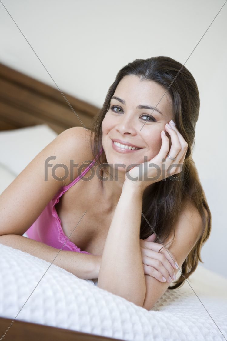 A Middle Eastern woman lying on a bed