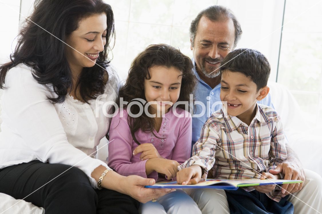 A Middle Eastern couple reading with their grandchildren