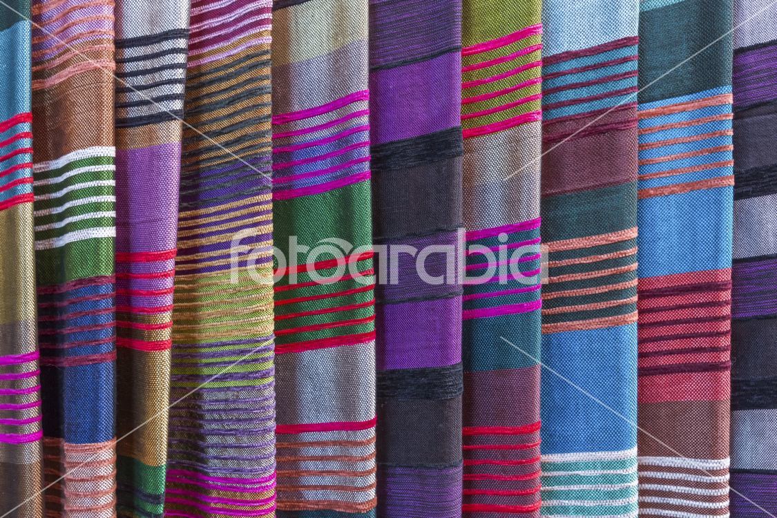 Colorful fabrics for sale on a market in Morocco