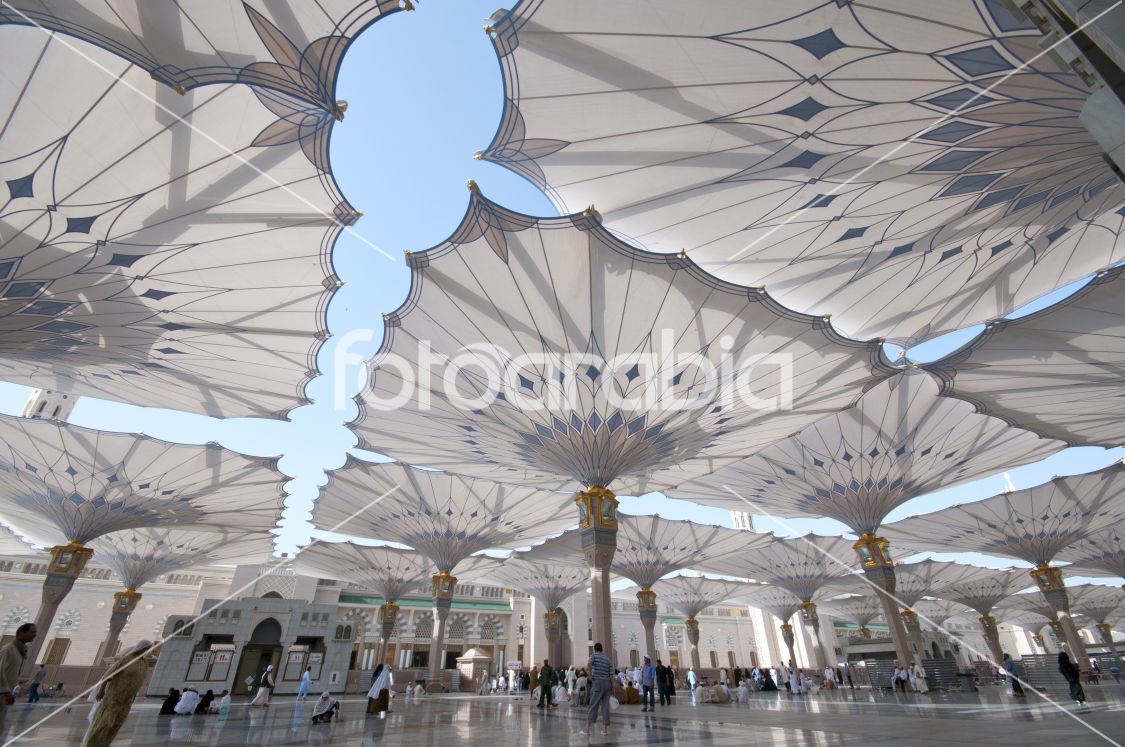 Pilgrims walk underneath giant umbrellas at Nabawi Mosque compound