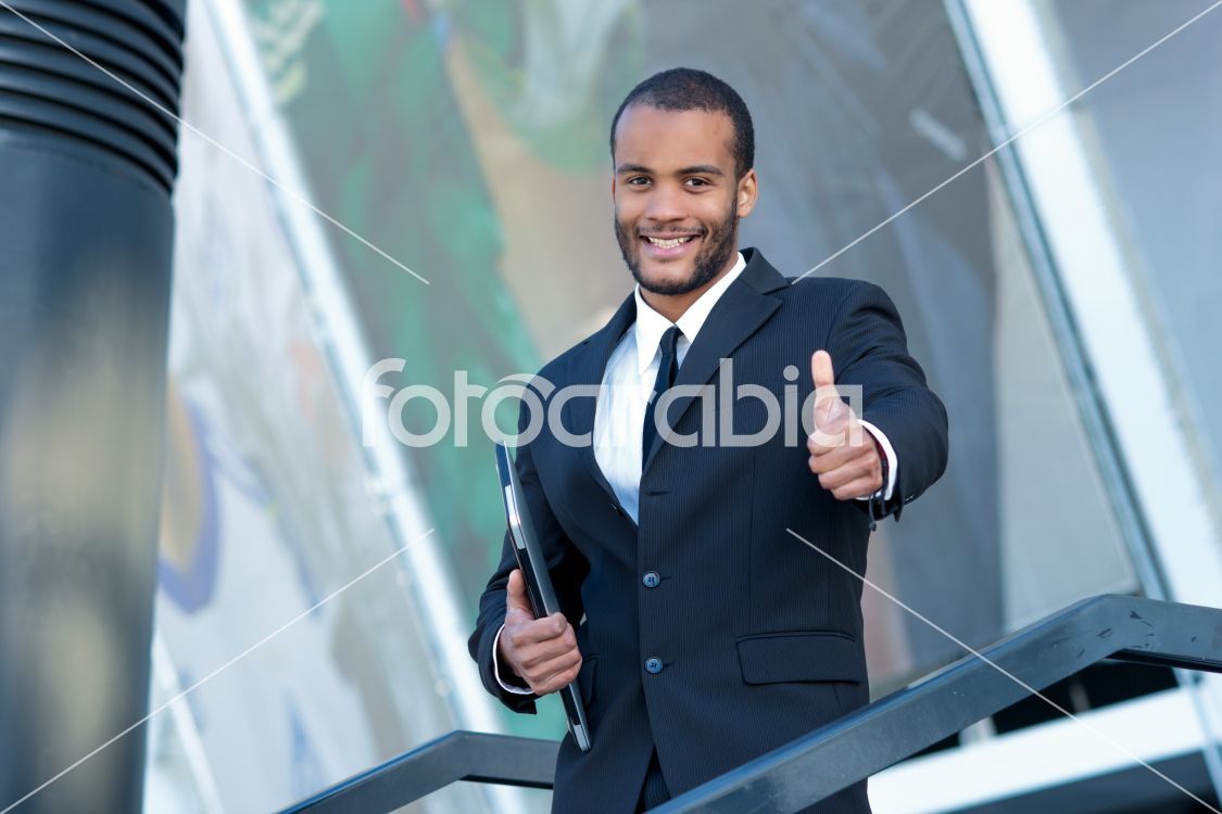A successful businessman showing thumb up. Confident African bus