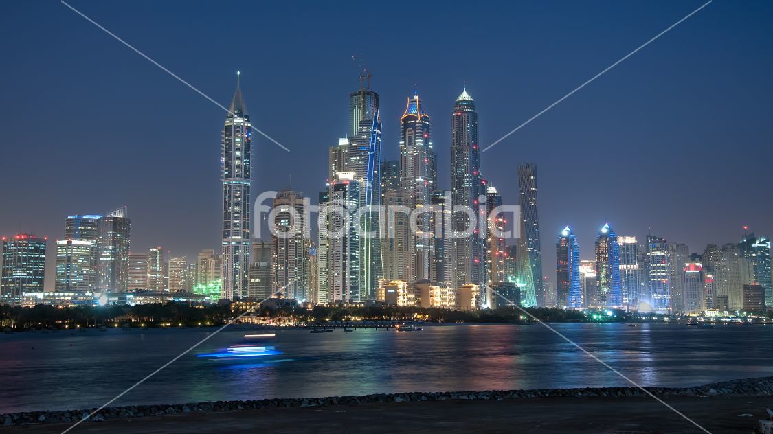 A skyline view of Dubai Marina showing the Marina and JBR. Dubai Marina is an artificial 3 km canal carved along the Persian Gulf shoreline